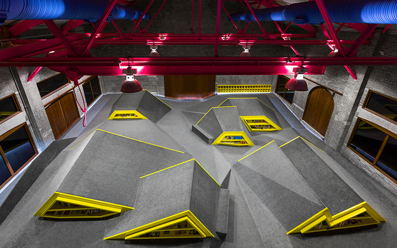 Illustration for article titled A Mountain Range of Shelves Turns This Kids' Library Into a Playground